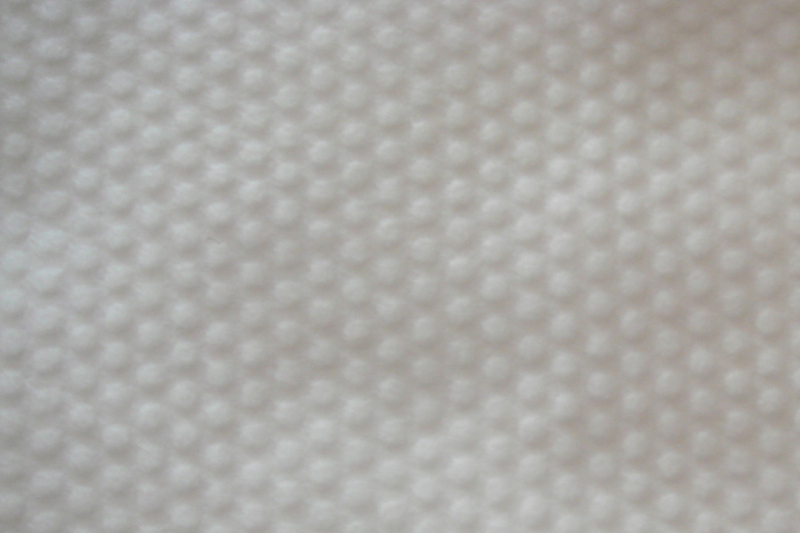 Is using embossed spunlace non-woven fabric beneficial to enhance grip?